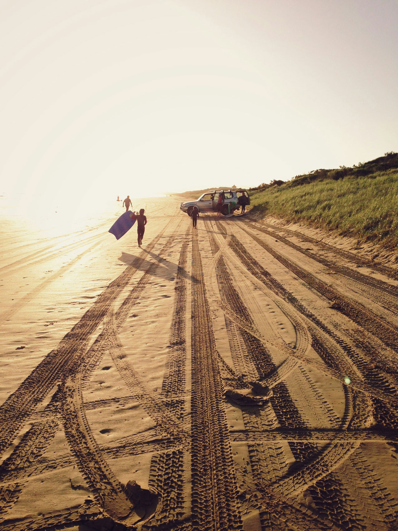 tire tracks on a beach intertwine